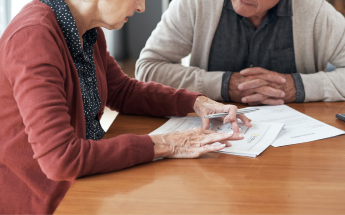 couple sitting at table with paperwork
