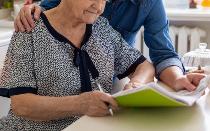 elderly couple looking at paperwork