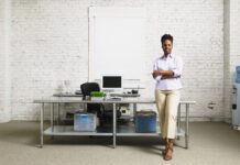middle aged women standing by desk