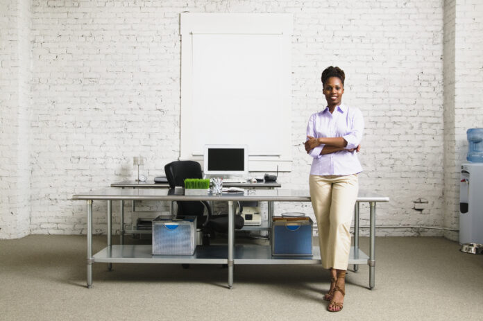 middle aged women standing by desk