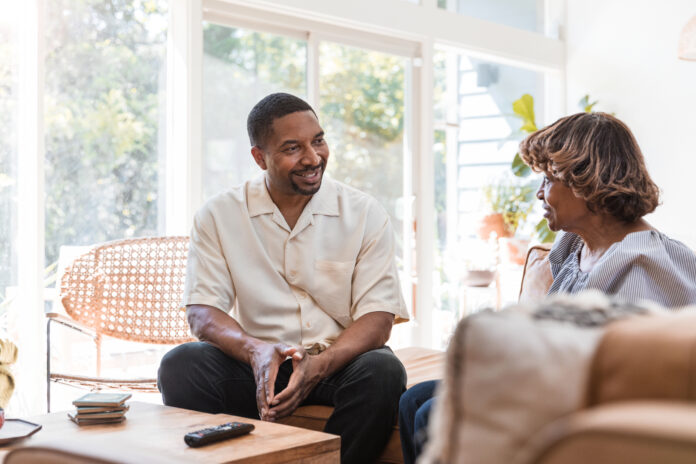 adult son visits senior mother