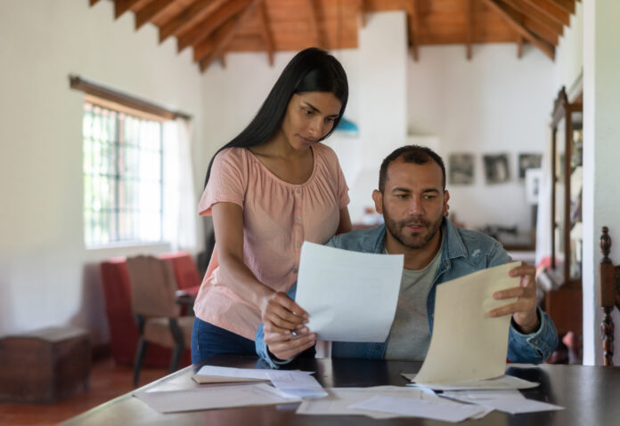 Couple in rural house organizing their finances