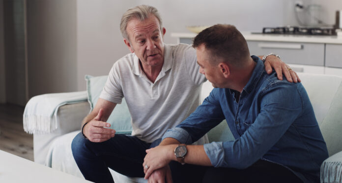 father and son talking in a home