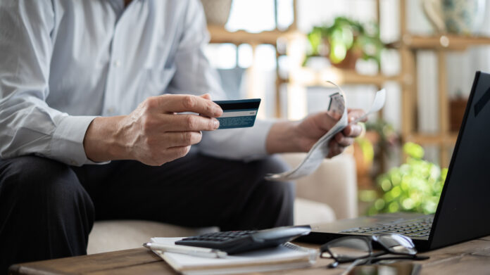 Close-up senior man with bills and credit card