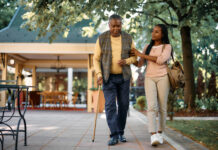 Texas Guardianships: Explaining the Procedure for a Simple Guardianship Smiling woman walking with her senior father while visiting him at nursing home.