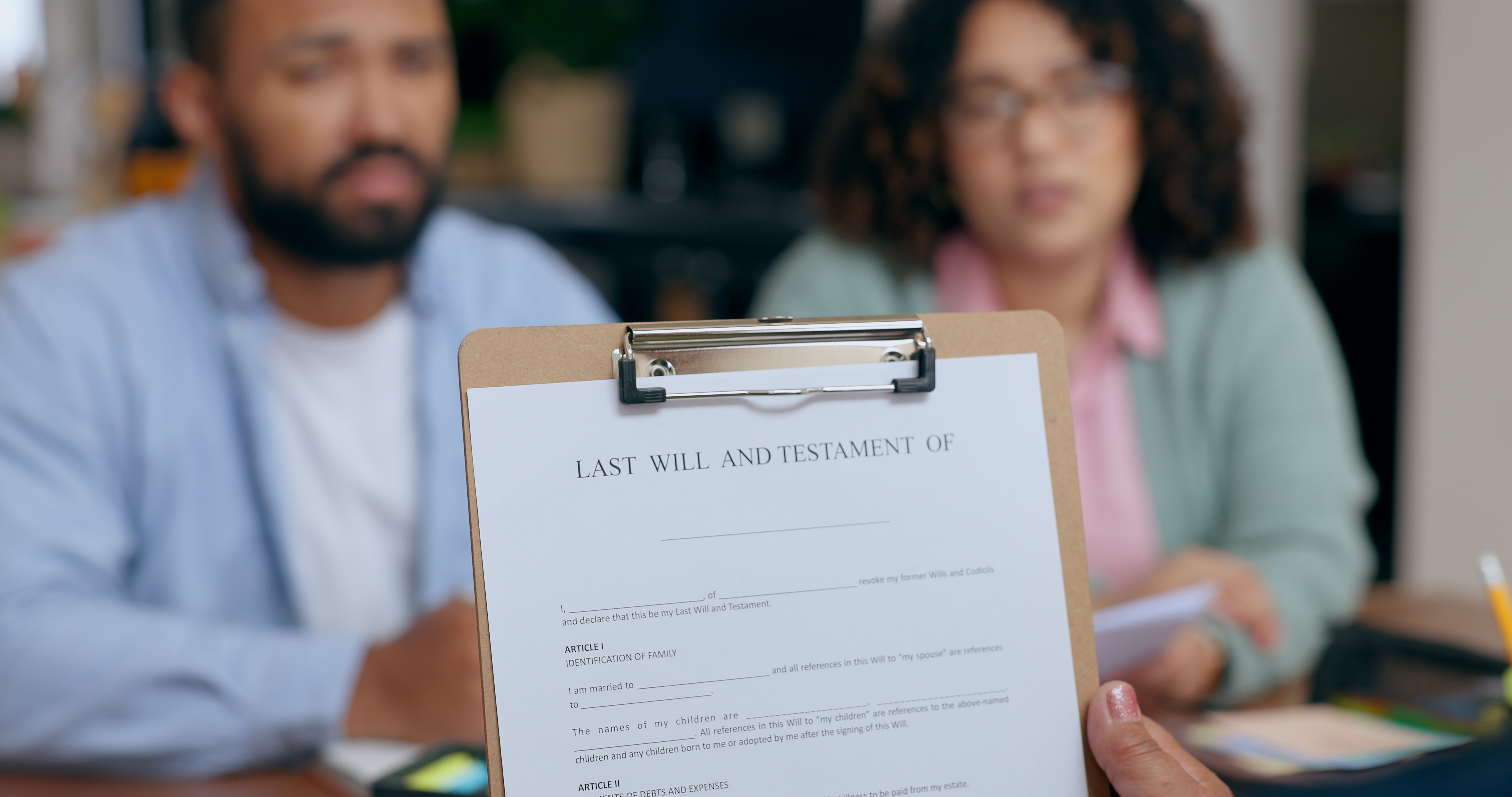Closeup of hand holding last will and testament