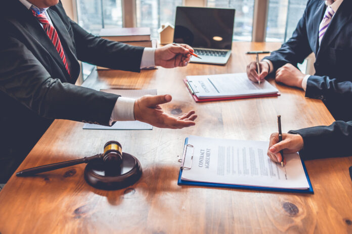 business people and lawyers discussing contract papers.Legal planning. Concepts of law, advice, legal services
