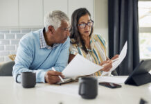 Making an Enforceable Will in Texas An older couple is sitting at their kitchen table reviewing financial documents.