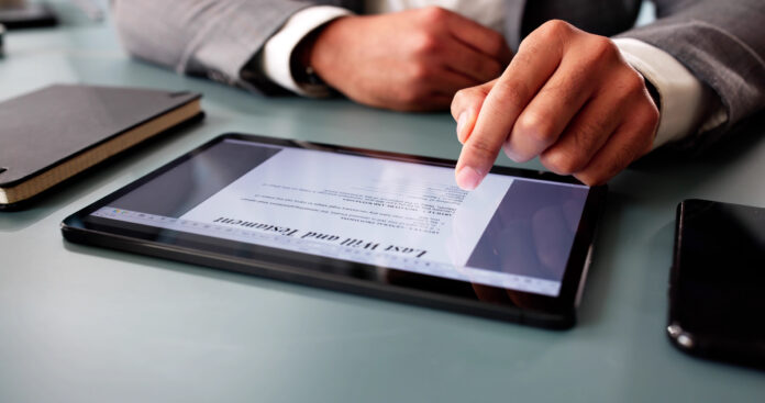 Man signs digital last will online, ensuring legal documentation recorded.