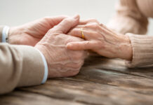 Aged married couple holding hands